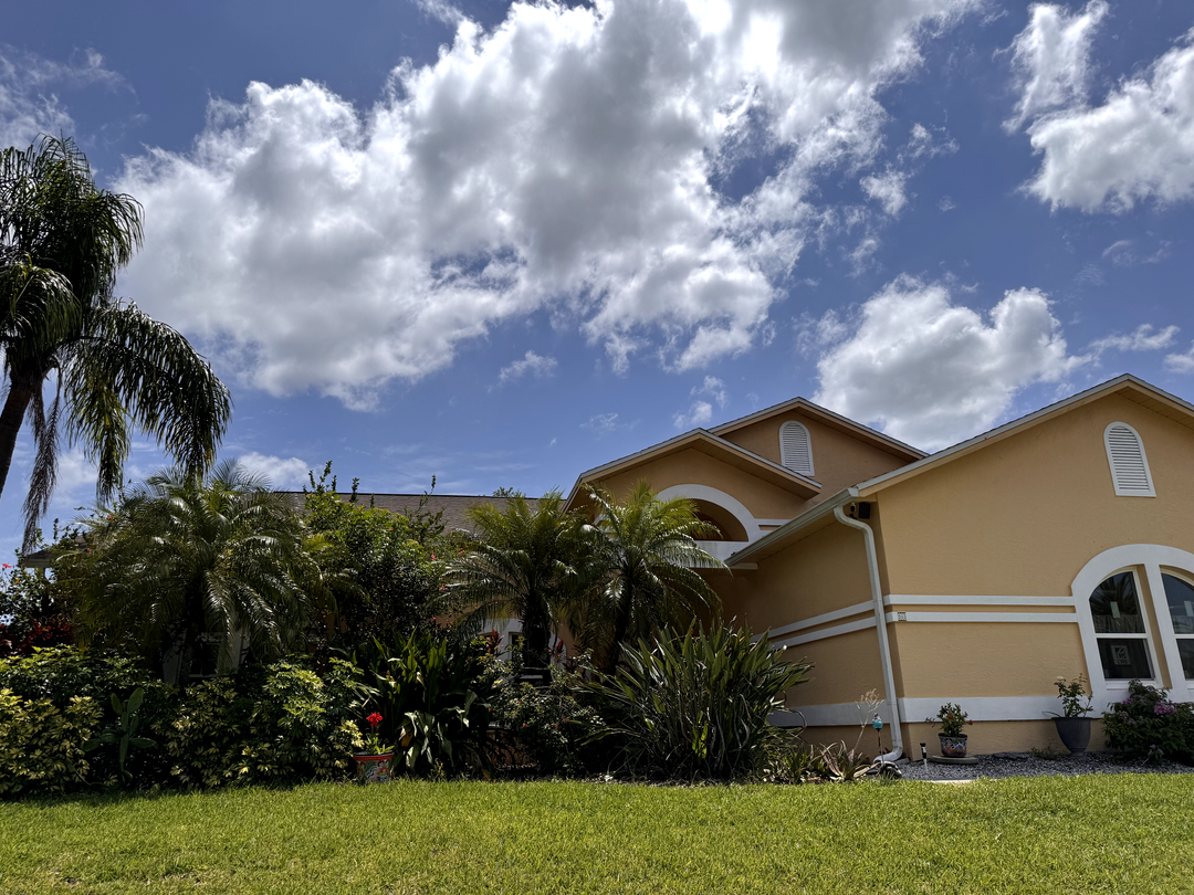 Home exterior with roof and landscaping